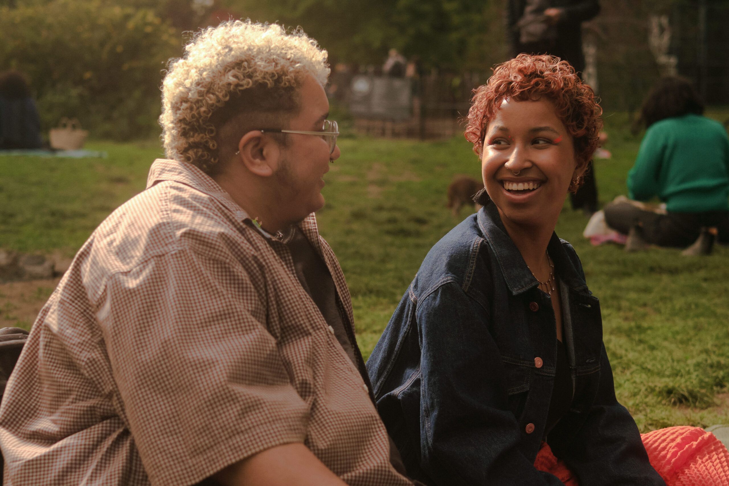 A trans couple sharing a moment in the park